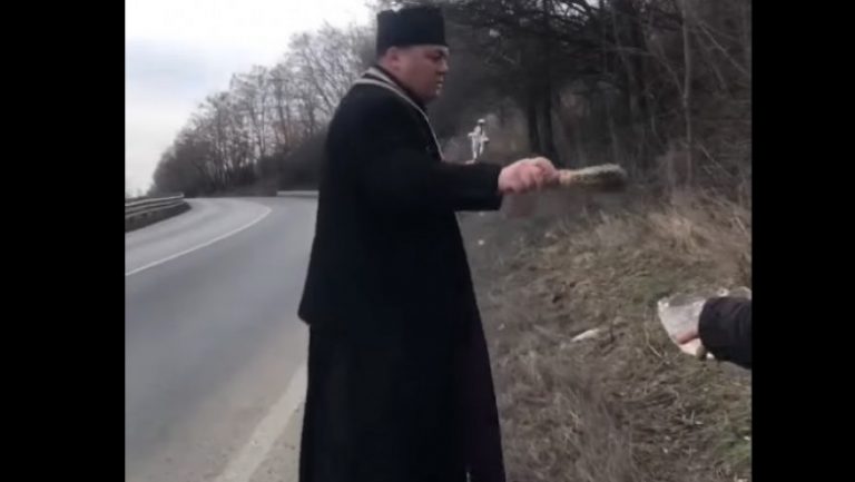 Bless those roads. Romanian priest sprinkles accident blackspot with holy water