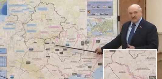 An official image handout by Belarus shows Belarus President Alexander Lukashenko standing next to a map purportedly detailing Russia's combat plan to capture Ukraine's major cities. EyePress News/Shutterstock