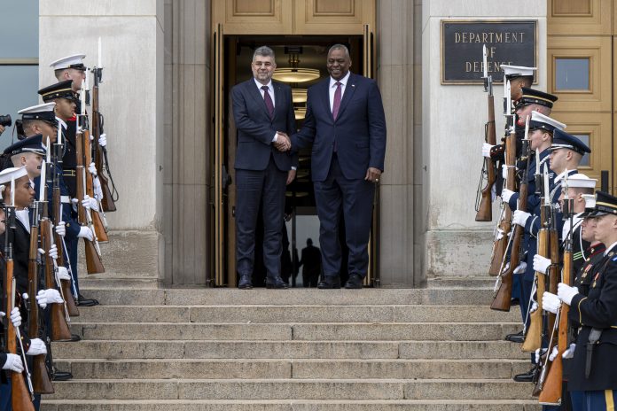Secretary of Defense Lloyd J. Austin III and Romanian Prime Minister Marcel Ciolacu pose for a photo prior to a meeting at the Pentagon, Dec. 4, 2023.