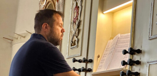 Organist Bruno Roth in Saschiz church. Photo: Larry Luxner