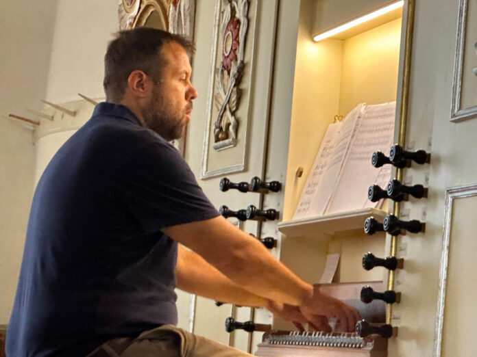 Organist Bruno Roth in Saschiz church. Photo: Larry Luxner